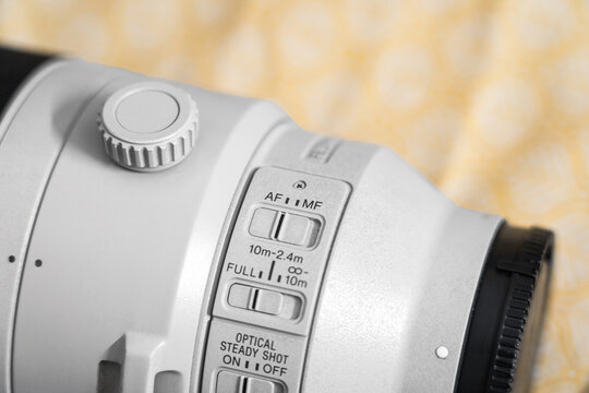 Auto-Focus and Manual Focus switch on a 200mm-600mm Super Telephoto Lens. Close-Up of Professional Telephoto Lens Controls for Wildlife Photography.