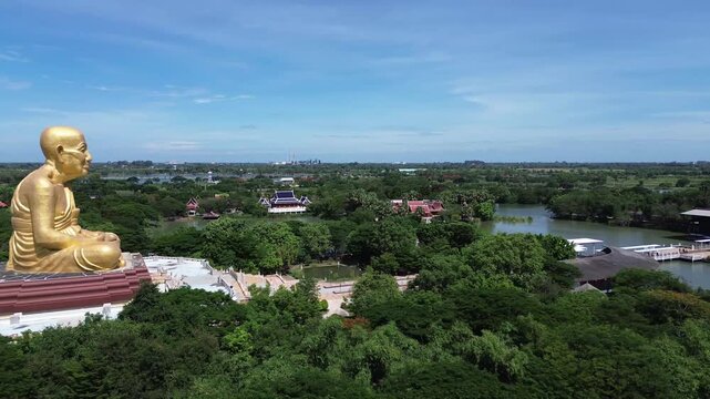 Aerial view of Luang Pu Thuad a huge golden monk statue , Ayutthaya, Thailand