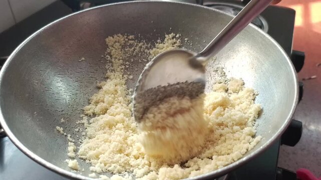 Macro Shot of Roasting Semolina (Suji) in a Steel Pan