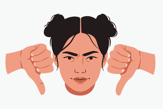 Frustrated woman with dark hair in double buns making an angry face while giving a double thumbs down gesture of disapproval.