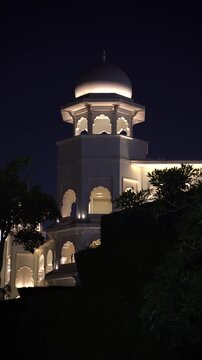 Stunning night view of an illuminated luxury heritage palace featuring traditional Indian architecture and a classic white dome pavilion.