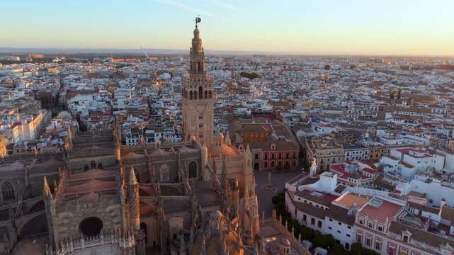 Aerial glimpse of Seville at sunset. Golden hour illuminates historic Seville city and architecture