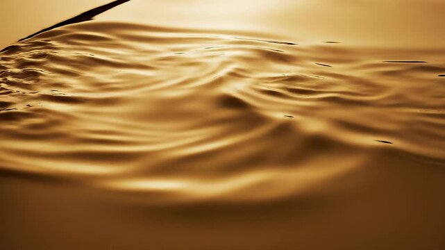 Static video scene with wave and oil texture effect concept. Golden liquid wave with smooth flowing texture and reflective surface in warm light