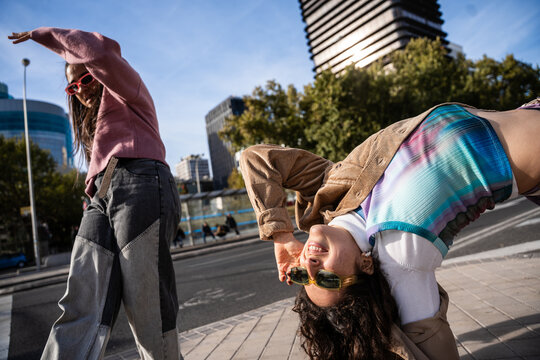 Gen-Z female urban dancers practicing street dance outdoors
