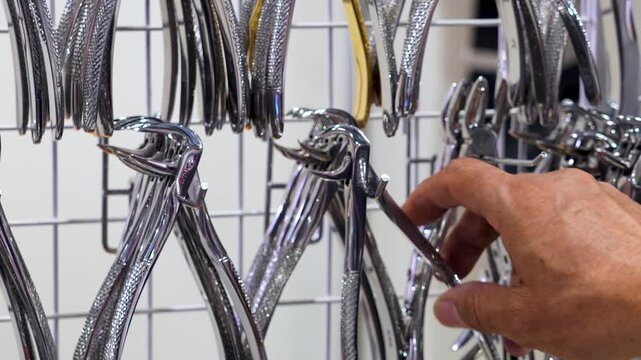 Dental pliers displayed in metal rows.