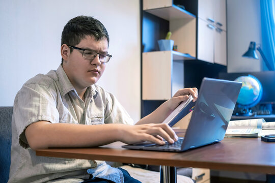 Lectures and lessons on the internet for high school students. Teenager boy study at home. Online education and distance learning for children. School boy doing his physics homework using gadgets.