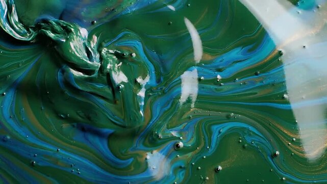 Abstract green and blue fluid paint art with swirling patterns and glossy texture
