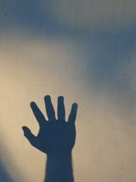 art of shadow arm gestures on the wall with shadow silhouettes printed on the frame, hand waving gestures a universal form of non-verbal communication used to greet, say goodbye, attract attention, or