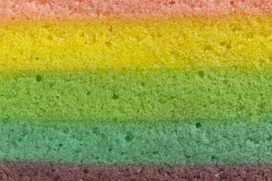 Close-up texture of a colorful layered rainbow cake sponge