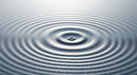 Fototapeta premium Concentric ripples radiate outwards across a shimmering liquid surface, creating a mesmerizing pattern of waves that gently expand and evolve, capturing the dynamic essence of a disturbance