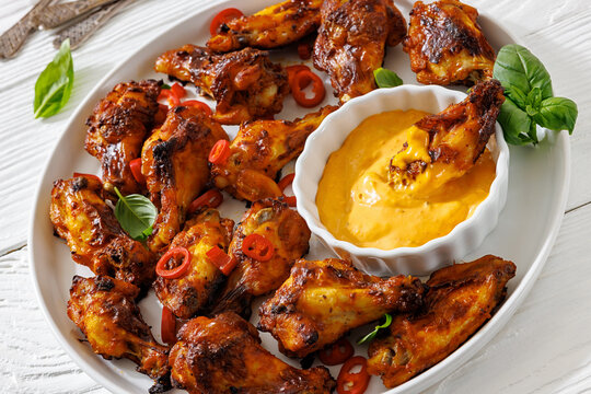 Appetizer chicken wings and creamy dip on a plate