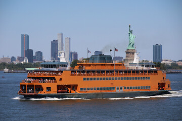 Staten Island Ferry sailing in New York Harbor with the Statue of Liberty in the background © ChiccoDodiFC