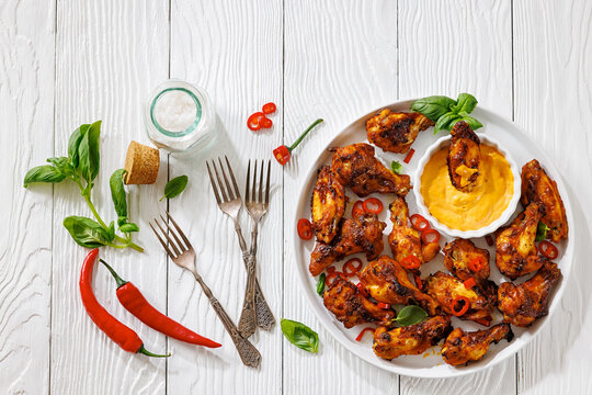 Roasted chicken wings appetizer with dip on plate