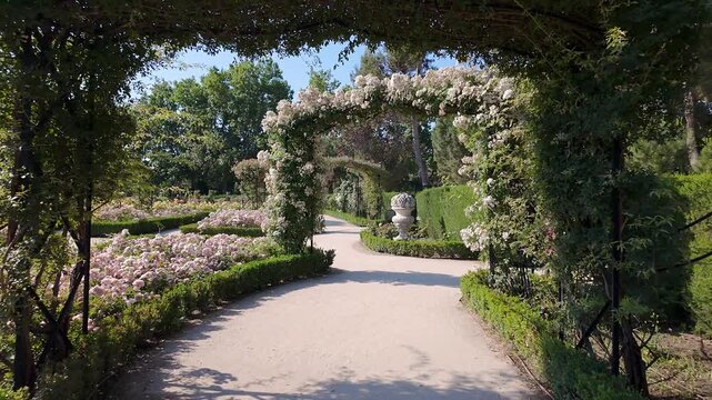 Beautiful arches made of plants with colorful flowers in the Retiro Park, Madrid.