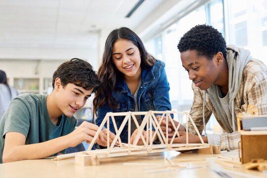 Students building bridge model in STEM workshop