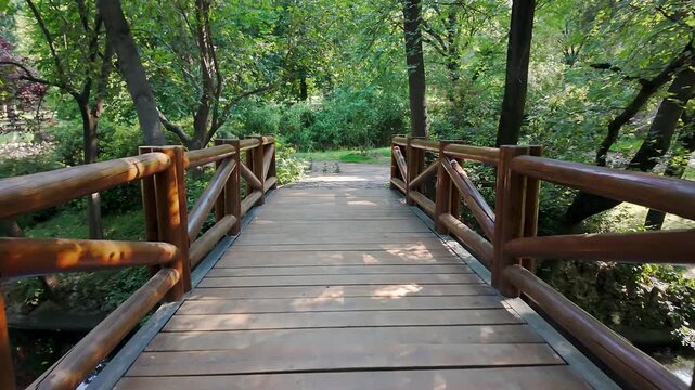 Romantic wooden bridge over a small pond in the Retiro Park in Madrid, Spain.