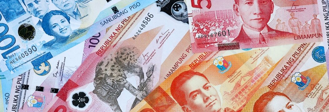 Philippine peso money banknotes bunch on table. Philippines bills of PHP currency close up