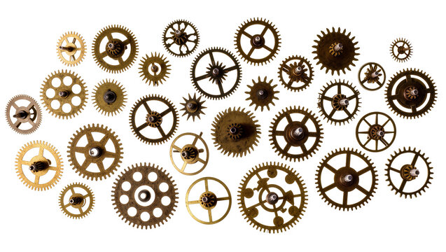 Isolated vintage antique brass clockwork gears and intricate wheel parts on display