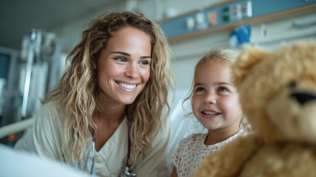 A joyful moment shared between a compassionate nurse and a smiling young girl holding a teddy bear, showcasing warmth and comfort in a hospital setting.