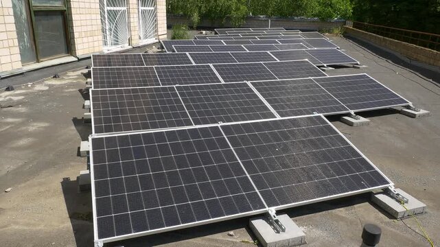 The Concept of Green Energy in an Urban Environment. Solar panels on the roofs of old apartment buildings. A rooftop solar power plant.