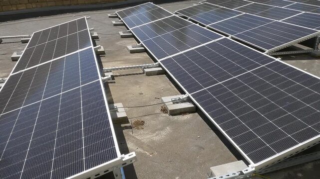 The Concept of Green Energy in an Urban Environment. Solar panels on the roofs of old apartment buildings. A rooftop solar power plant.