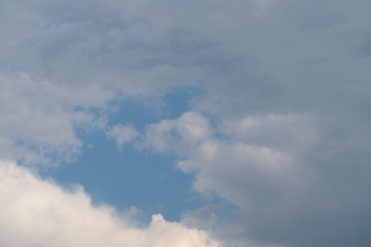 Serene sky scene. Calm clouds with hopeful glow. Peaceful blue sky with gentle lighting effects. Sky peering through clouds with soft illumination and inviting textures