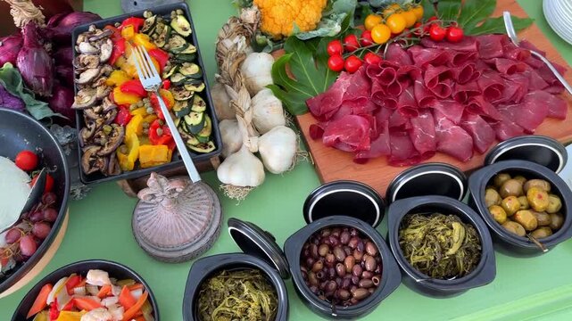 Cinematic close-up of luxury wedding aperitif table styled in French gourmet style with fresh vegetables, fruits, cheeses, olives, pickles, and sauces for elegant reception dining.