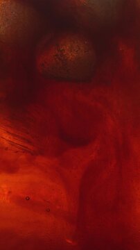 macro shot of coffee pouring into strawberry cocktail with ice cubes in glass. Beautiful liquid mixing process creating refreshing summer beverage with layered texture.