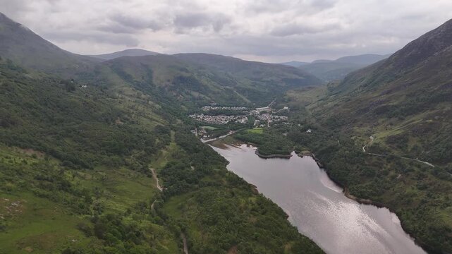Aerial drone push forward shot of Loch Leven at the village Kinlochleven, part of the West Highland Way in Scotland.