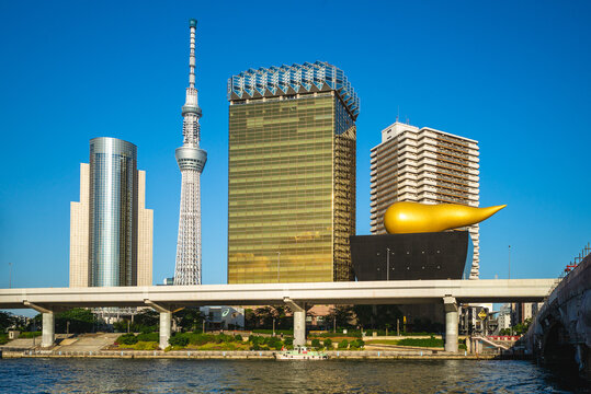 June 13, 2019: Asahi Beer Hall, which was designed by French designer Philippe Starck and completed in 1989, is located on bank of Sumida River with tokyo skytree tower in Tokyo city, Japan