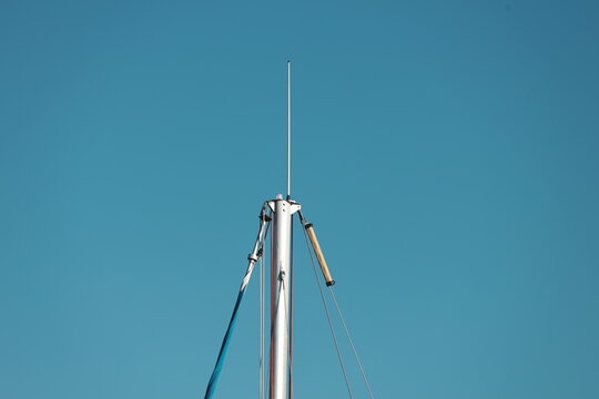 A sailboat mast with a flag on it