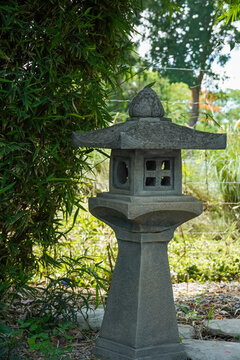Stone lantern in a tranquil garden setting with lush green bamboo foliage
