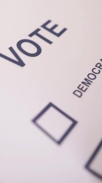 A U.S. citizen holding a ballot at a polling station during the U.S. Congressional midterm elections