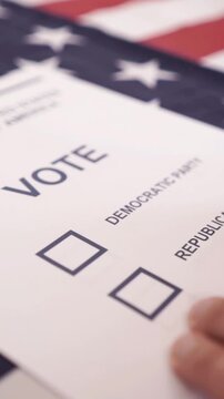 A U.S. citizen holding a ballot at a polling station during the U.S. Congressional midterm elections