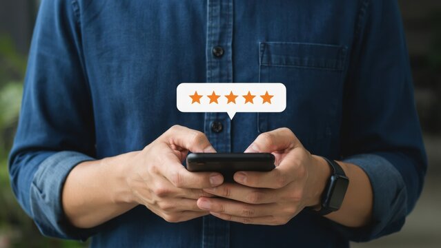 Person using a smartphone to give a five star rating for an excellent service review