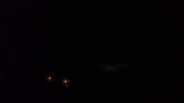 Night thunderstorm lightning timelapse over house roofs and trees