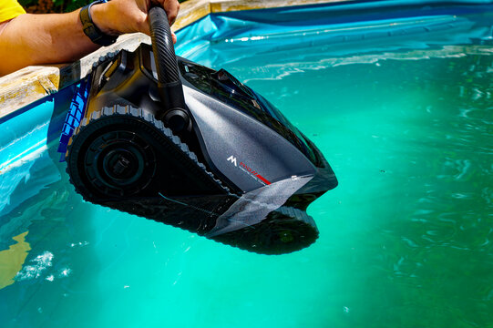 Berlin, Germany &ndash; May 29, 2026: A pool robot is being lowered into a swimming pool.