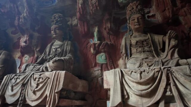 Dazu, China: Panoramic footage of a pair of bodhisattva statues, part of Baodingshan grottoes in Dazu rock carvings, famous rock art in Chongqing, China. The site date from the 9th to the 13th century