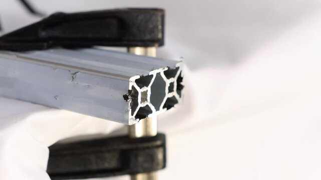 Tapping Bolt Hole in Aluminum Extrusion Profile Using Hand Tap Tool for Precision Metalwork, Engineering Assembly, Industrial Manufacturing Process and Mechanical Fastening Demonstration