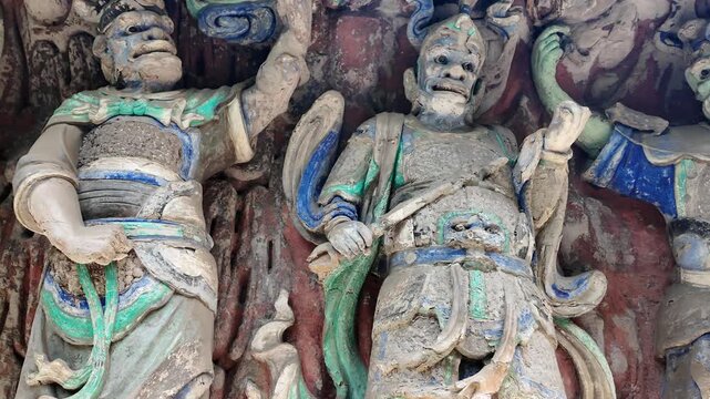 Dazu, China: Footage of walking along statues, part of Baodingshan grottoes in Dazu rock carvings, famous cave rock art in Chongqing dating from the 8th century in China