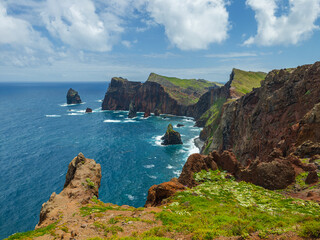 Majestic rocky cliffs of Ponta do Rosto meeting the deep blue waters of the Atlantic Ocean in São Lourenço peninsula, Madeira, Portugal. © volff