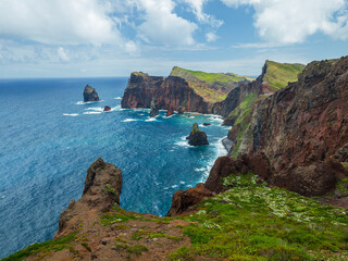 Majestic rocky cliffs of Ponta do Rosto meeting the deep blue waters of the Atlantic Ocean in São Lourenço peninsula, Madeira, Portugal. © volff