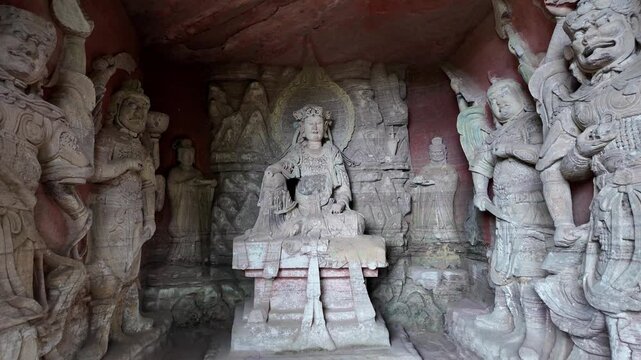 Dazu, China : Tilt down footage of ancient Buddhist and other deities statues in the Beishan grottoes in Dazu rock carvings, dates back to the 9th century under the Tang dynasty near Chongqing, China