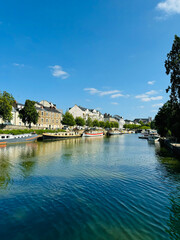Fototapeta premium Houseboats moored along a calm canal in Nantes, France