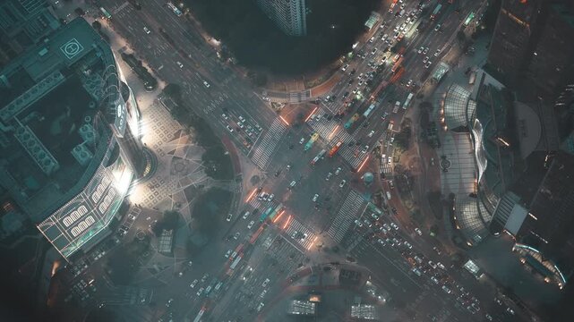 Top down night view of busy Jamsil intersection and illuminated city street in Seoul - 화려한 조명의 빌딩과 복잡한 대각선 교차로 차량 흐름이 어우러진 잠실역 사거리 야경 풍경