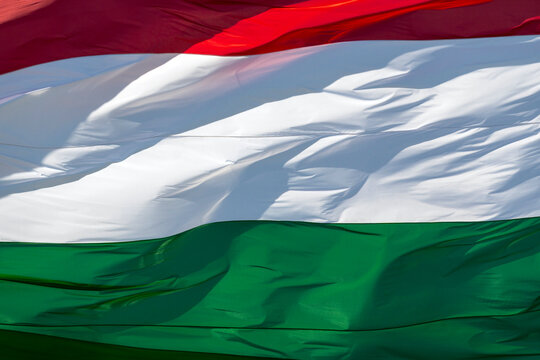 Hungarian flag waving in the wind during a sunny day at a public event in Hungary