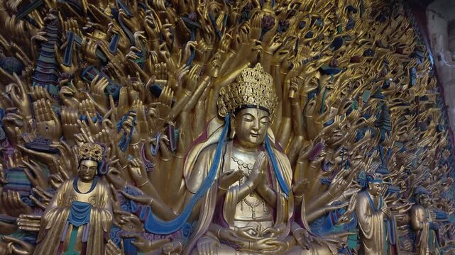 Dazu, China : Tilt down footage of thousand-hand Guanyin (Avalokitesvara), famous statue in Baodingshan grottoes date from the 9th to the 13th century located in Dazu rock carvings of Chongqing, China