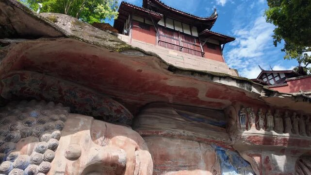 Dazu, China : Tilt down footage from temple to reclining Buddha representing its reaching nirvana in Baodingshan grottoes that date from the 9th located in Dazu rock carvings near Chongqing, China
