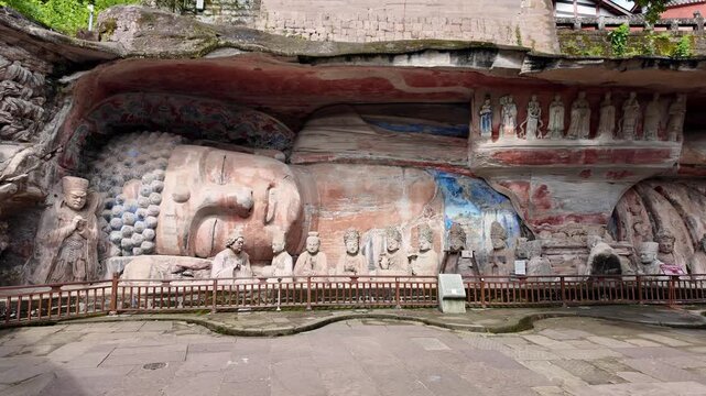 Dazu, China : Close up panoramic footage of Buddha entering nirvana, iconic statue in Baodingshan grottoes that dates from the 9th century located in Dazu rock carvings near Chongqing in China