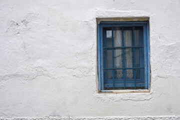 Fototapeta premium blue window on a traditional Andalusian white wall